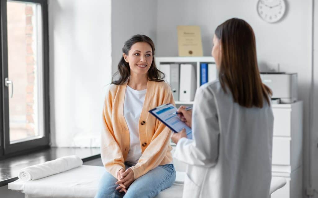 A woman discusses medication management during detox with her doctor. 