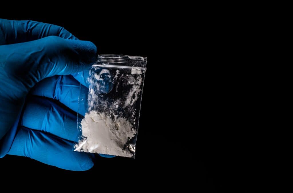 baggie of fentanyl held by a gloved hand