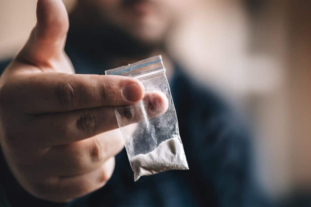 baggie of cocaine held out by person