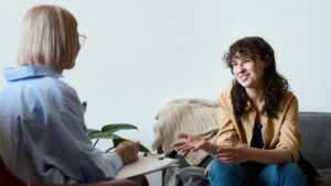 A young woman talking to her therapist during CBT in Pompano Beach, FL.