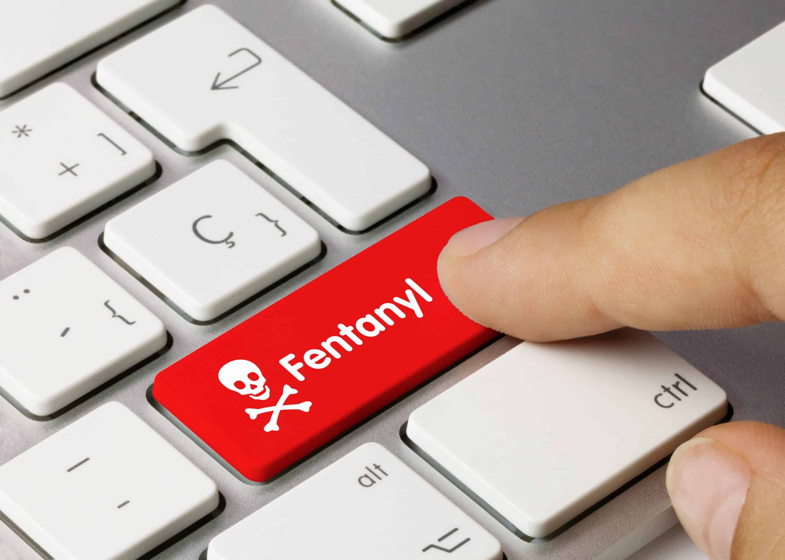 person with finger on a red keyboard key that says fentanyl