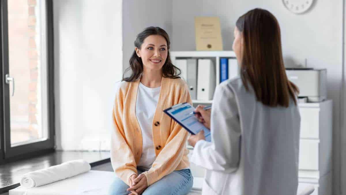 A woman wondering what is detox like discusses medication management with her doctor. 