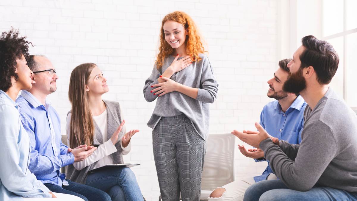 A woman happy to talk about depression during detox and share experiences at a group therapy. 