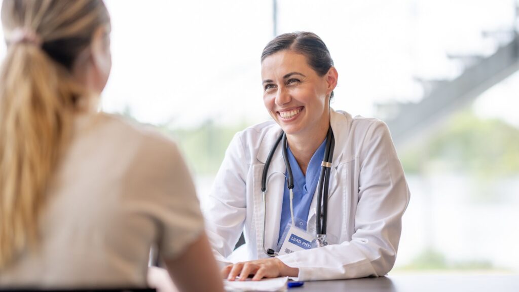 Professional speaking with a patient during an assessment at Florida medication-assisted treatment.