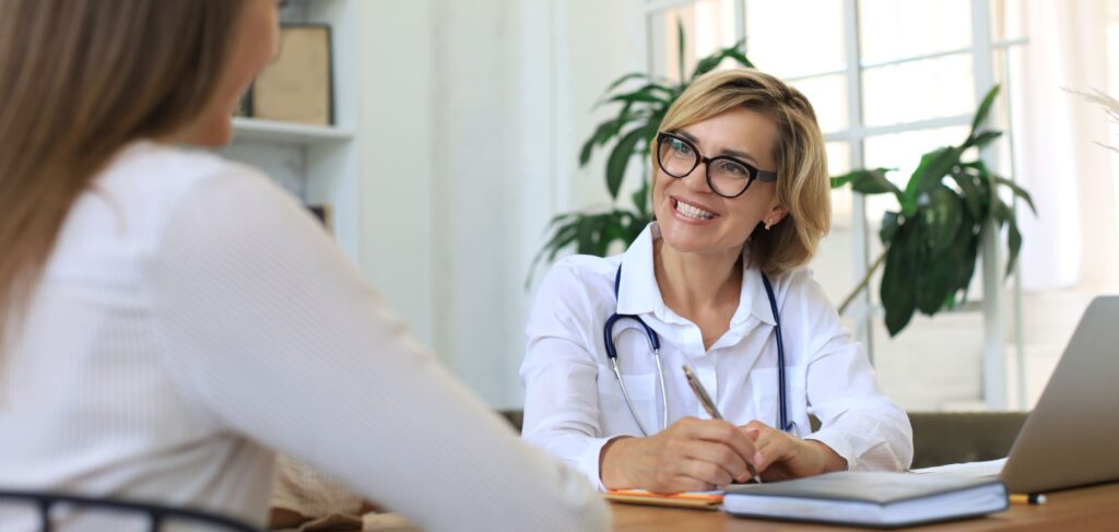 A professional discusses rehab services covered by insurance with a client.