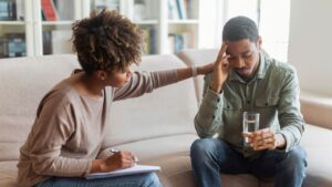 A man receives therapeutic support during alcohol detox.