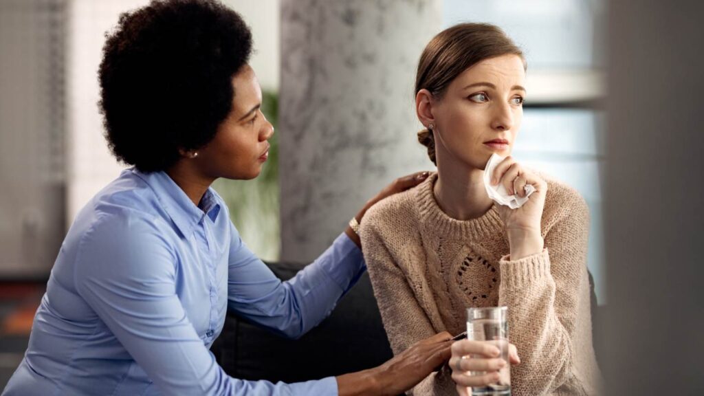 Therapist supporting a woman in OCD and addiction recovery.
