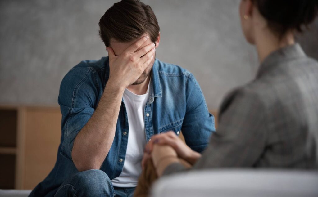 Man receiving therapeutic support for post-traumatic stress disorder.