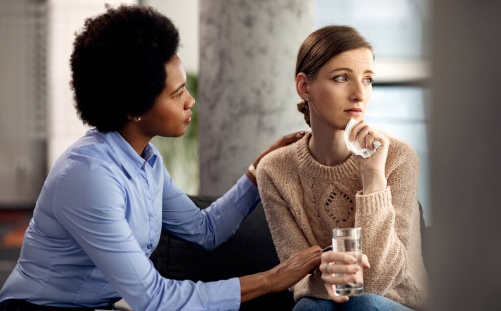 Therapist supporting a woman during PTSD treatment in Pompano Beach, FL.