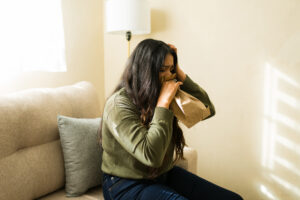 A person experiencing severe anxiety symptoms that show when to seek inpatient treatment for anxiety.