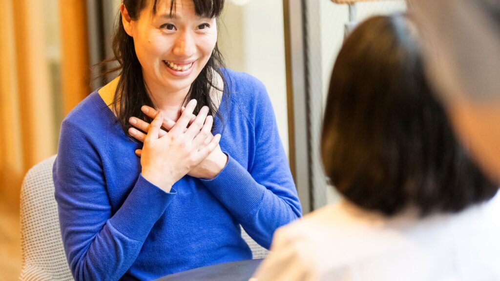 Woman in blue feeling hopeful after undergoing Residential Rehab