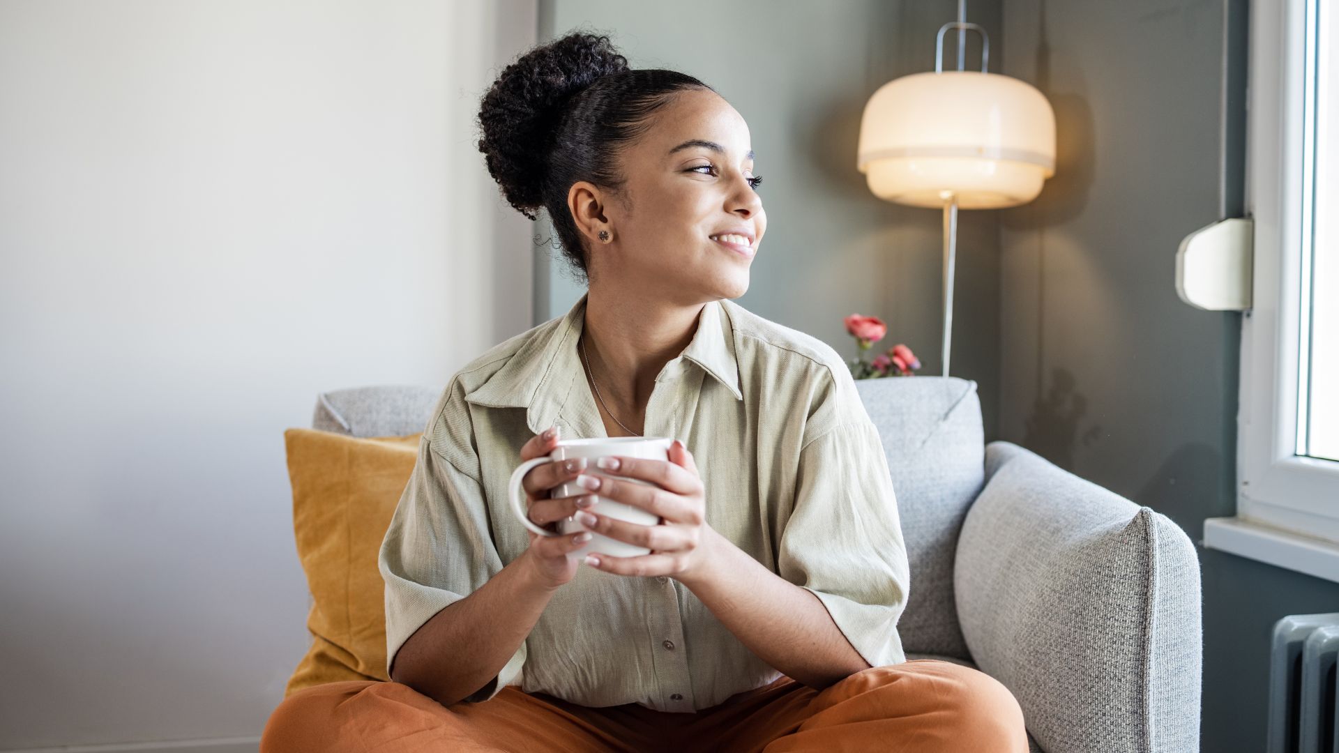 Woman smiling with a cup of tea after successful Alcohol Rehab