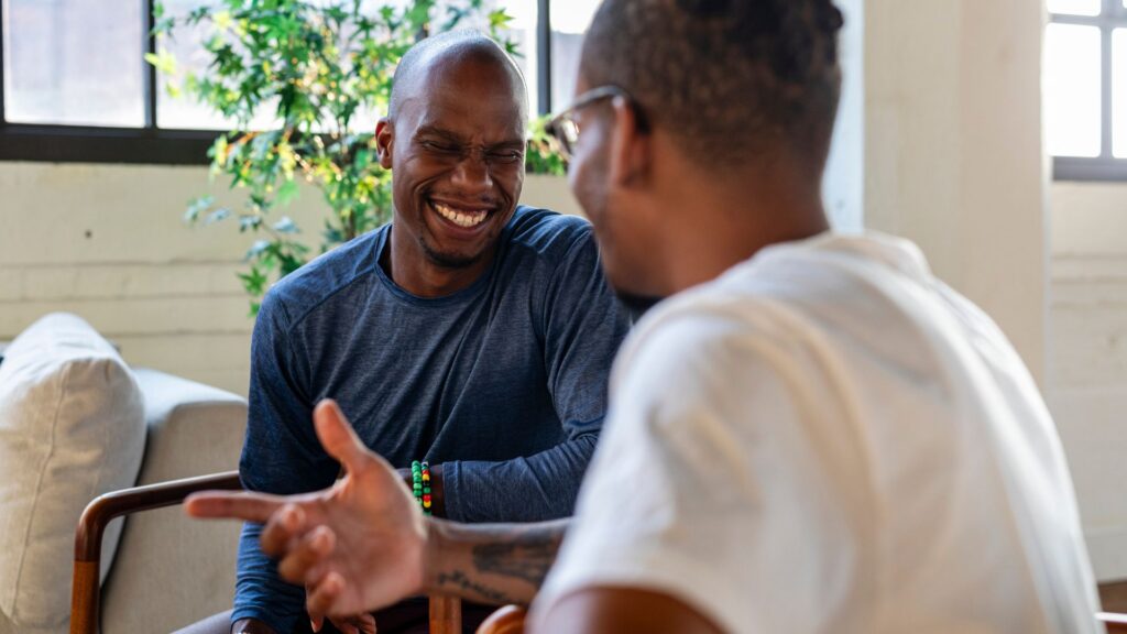 Two male smiling after alcohol rehab treatement